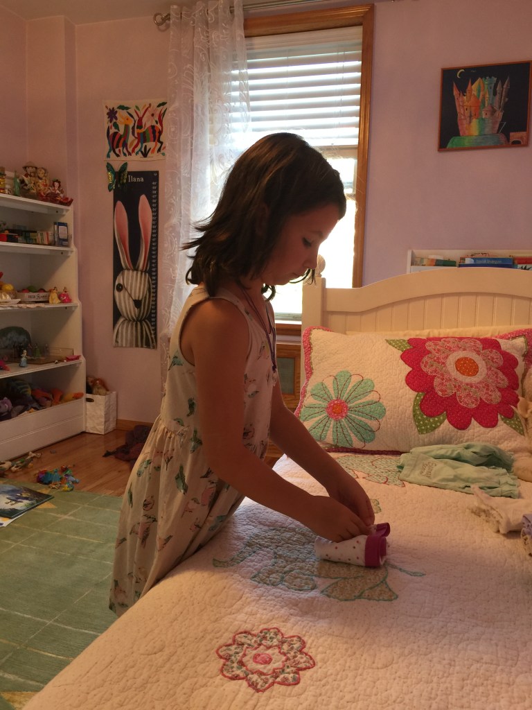 Little girl folding her underwear